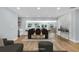 A dining room showcases an oval table, seating for six, and a bar area with white cabinets and natural wood shelves at 1842 Oklahoma Ne Ave, St Petersburg, FL 33703