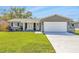Charming gray brick home with a well-maintained lawn, a two-car garage and an inviting front entrance at 1842 Oklahoma Ne Ave, St Petersburg, FL 33703