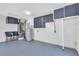 Well-organized two-car garage featuring epoxy flooring and built-in storage cabinets at 1842 Oklahoma Ne Ave, St Petersburg, FL 33703