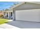 Two car garage with a newly paved driveway on a charming gray brick home at 1842 Oklahoma Ne Ave, St Petersburg, FL 33703