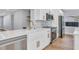 Gourmet kitchen boasts white cabinetry, quartz countertops, and stainless steel appliances at 1842 Oklahoma Ne Ave, St Petersburg, FL 33703