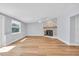 Bright living room features fireplace, ceiling fan, and large windows at 1842 Oklahoma Ne Ave, St Petersburg, FL 33703