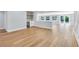 Bright living room with wood floors, access to a lanai, and a bar area with built-in cabinets and open shelving at 1842 Oklahoma Ne Ave, St Petersburg, FL 33703