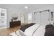Staged bedroom featuring a walk-in closet and bathroom with a wooden dresser and full length mirror at 1842 Oklahoma Ne Ave, St Petersburg, FL 33703