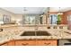 Close-up of the kitchen sink featuring granite countertops, stainless steel faucet, and tile backsplash at 2114 Fawn Meadow Dr, Valrico, FL 33594