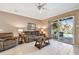 Comfortable living room with leather furniture and a view of the pool and lanai at 2114 Fawn Meadow Dr, Valrico, FL 33594