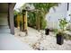Landscaped backyard featuring white gravel, tropical foliage, and a wooden archway at 2504 Avenue B # A, Bradenton Beach, FL 34217