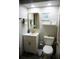 Bathroom with white vanity, gold mirror, and geometric tile floor at 2504 Avenue B # A, Bradenton Beach, FL 34217
