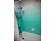 Relax in the modern bathtub featuring a showerhead and stylish blue and grey paint at 2504 Avenue B # A, Bradenton Beach, FL 34217