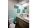 Charming bathroom with colorful wall art, modern fixtures, and stylish vanity with granite countertop at 2504 Avenue B # A, Bradenton Beach, FL 34217