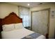 Comfortable bedroom featuring a wooden headboard, a bedside table, and soft lighting at 2504 Avenue B # A, Bradenton Beach, FL 34217