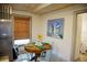 Cozy dining area showcasing round table with seating for four, complemented by nautical-themed artwork at 2504 Avenue B # A, Bradenton Beach, FL 34217