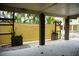 Exterior of home featuring covered space with privacy screen, tropical foliage, and pebble landscaping at 2504 Avenue B # A, Bradenton Beach, FL 34217