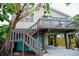 Inviting home exterior featuring a staircase, deck, and lush landscaping at 2504 Avenue B # A, Bradenton Beach, FL 34217