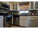 Well lit kitchen featuring stainless steel appliances, white cabinets, and a decorative backsplash at 2504 Avenue B # A, Bradenton Beach, FL 34217