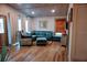 Bright living room featuring wood-look floors, a comfortable sectional and an accent chair at 2504 Avenue B # A, Bradenton Beach, FL 34217