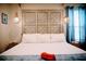 King size bed with decorative headboard, stylish lighting, and ample natural light from window at 2504 Avenue B # A, Bradenton Beach, FL 34217
