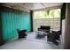 Cozy outdoor patio with wicker furniture, a patterned rug, and a wooden slatted privacy screen at 2504 Avenue B # A, Bradenton Beach, FL 34217