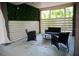 Outdoor patio featuring seating, a rug, a privacy screen, and views of tropical foliage at 2504 Avenue B # A, Bradenton Beach, FL 34217