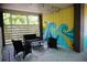 Outdoor patio with comfortable seating, stylish rug, string lights, and colorful wave mural at 2504 Avenue B # A, Bradenton Beach, FL 34217