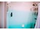 Relaxing shower area features two-tone wall design and convenient shower caddy at 2504 Avenue B # A, Bradenton Beach, FL 34217