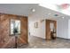 Hallway featuring tiled flooring, wood paneling, and decorative mirrors, creating a welcoming entrance at 2587 Countryside Blvd # 6103, Clearwater, FL 33761