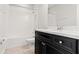 Bathroom featuring tub, toilet, dark cabinets, granite countertop, sink, and fixtures at 26325 Limestone Springs Way, Wesley Chapel, FL 33544