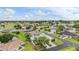 An aerial view showcasing the community with scenic views of lush greenery and a golf course at 29312 Marker Loop, San Antonio, FL 33576