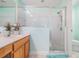 Well-lit bathroom featuring a glass-enclosed shower and a wooden vanity at 29312 Marker Loop, San Antonio, FL 33576