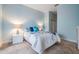 Bright bedroom featuring a comfortable bed with stylish bedding and coordinated lamps at 29312 Marker Loop, San Antonio, FL 33576