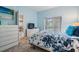 Inviting bedroom with blue accents, carpeted floors, and a slider to the lanai at 29312 Marker Loop, San Antonio, FL 33576