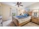 Cozy bedroom featuring a wooden bed frame, ceiling fan, and neutral-toned decor at 29312 Marker Loop, San Antonio, FL 33576