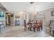 Elegant dining room with modern chandelier and wood table with seating for six at 29312 Marker Loop, San Antonio, FL 33576