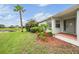 Well-maintained home exterior featuring lush landscaping, a pond, and a welcoming entrance at 29312 Marker Loop, San Antonio, FL 33576