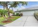 Charming single-story home with mature trees, landscaping, and a spacious driveway at 29312 Marker Loop, San Antonio, FL 33576