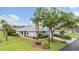 Well-maintained single-story home with a two-car garage, lush landscaping, and mature trees in a quiet neighborhood at 29312 Marker Loop, San Antonio, FL 33576