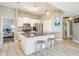Modern kitchen featuring stainless steel appliances, white cabinets, and a gray granite island at 29312 Marker Loop, San Antonio, FL 33576