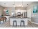 Bright kitchen featuring stainless appliances, white cabinets, and an island with seating at 29312 Marker Loop, San Antonio, FL 33576