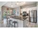 Modern kitchen featuring stainless steel appliances, granite countertops, and a stylish breakfast bar with seating at 29312 Marker Loop, San Antonio, FL 33576