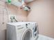 This laundry room features a Samsung washer and dryer and convenient overhead storage shelves at 29312 Marker Loop, San Antonio, FL 33576