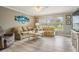 Bright and airy living room with neutral walls, wood-look flooring, and plenty of natural light at 29312 Marker Loop, San Antonio, FL 33576