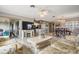 Open-concept living space with wood-look floors, neutral paint, and seamless flow to the kitchen and dining areas at 29312 Marker Loop, San Antonio, FL 33576