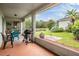 Screened-in patio with pond view, perfect for outdoor dining and entertaining in a relaxing setting at 29312 Marker Loop, San Antonio, FL 33576