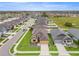 Aerial view of the home showcasing the roof, landscaping, and surrounding neighborhood at 313 Old Windsor Way, Spring Hill, FL 34609