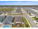 Aerial view of the property showing the pool, screened lanai and the neighborhood layout at 313 Old Windsor Way, Spring Hill, FL 34609