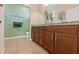 Bathroom with dual sinks and tile floor at 313 Old Windsor Way, Spring Hill, FL 34609