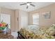 Bedroom with neutral walls, ceiling fan, closet, and a floral comforter set at 313 Old Windsor Way, Spring Hill, FL 34609