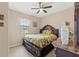 Comfortable bedroom with dark wood furnishings and a leafy comforter set at 313 Old Windsor Way, Spring Hill, FL 34609
