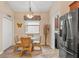 Cozy dining area features wicker furniture, a chandelier, and a view of the outdoor space at 313 Old Windsor Way, Spring Hill, FL 34609