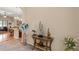 Elegantly decorated entryway with stylish console table, vase with flowers and tiled floors at 313 Old Windsor Way, Spring Hill, FL 34609